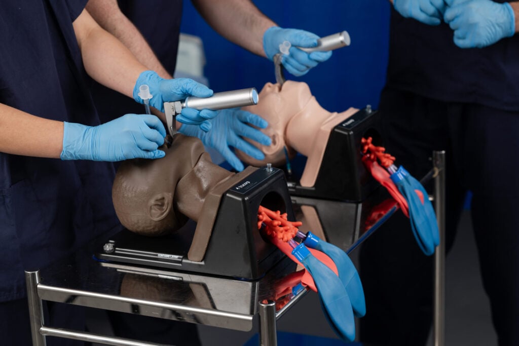Students practicing intubation using Trucorp manikins.