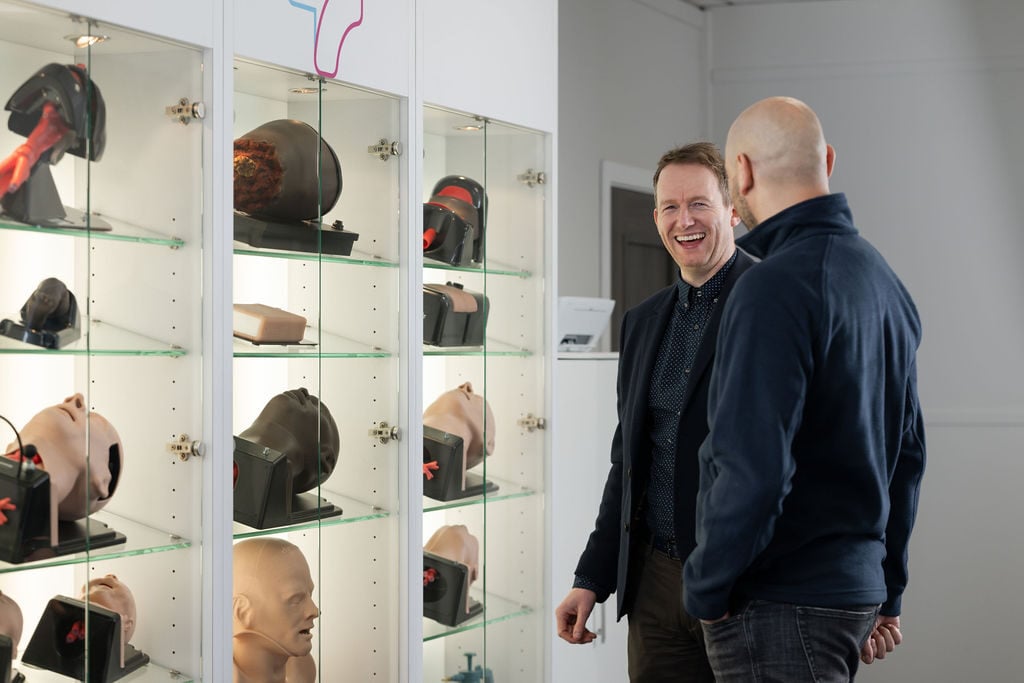 TruCorp medical training manikins display with two TruCorp directors