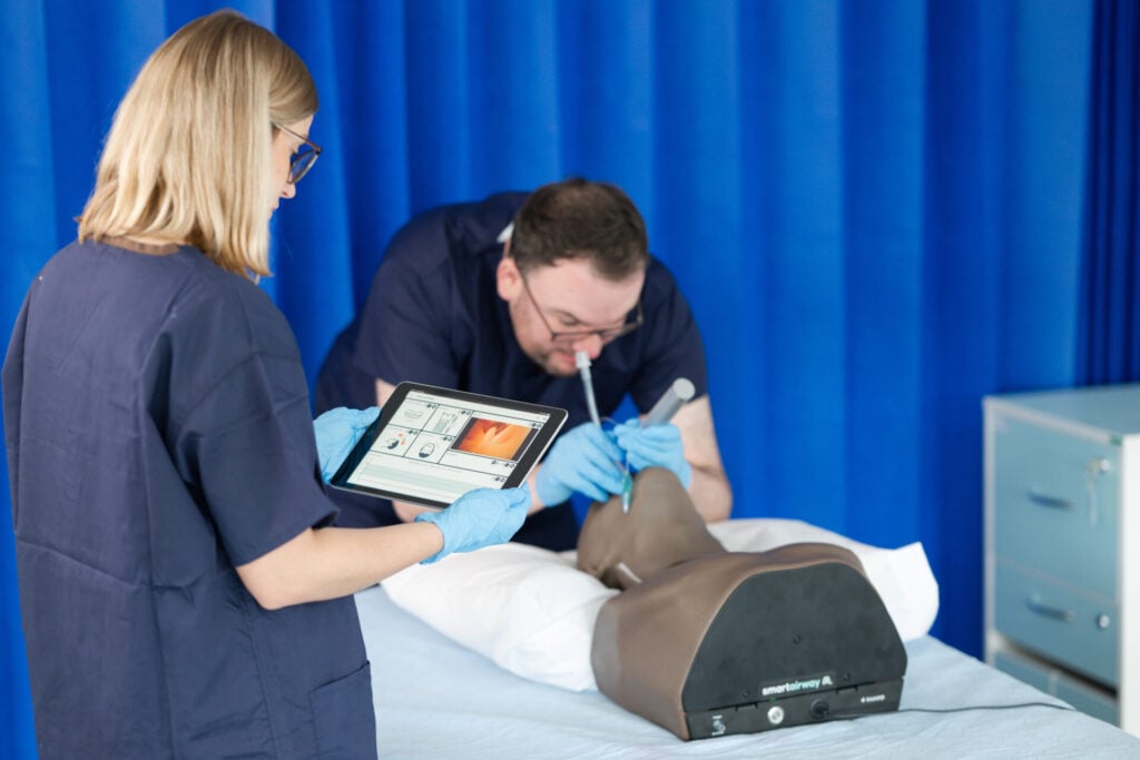 A student intubating with Smart Airway Adult with the guidance of the instructor.