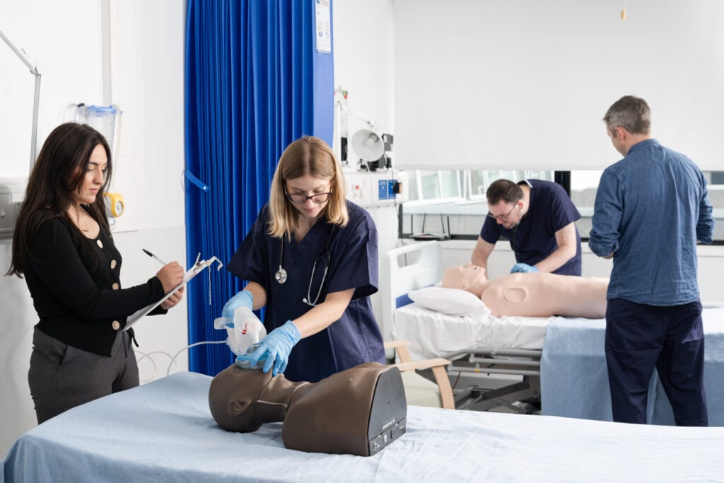 A classroom of students being assessed on different procedures using Trucorp's manikin.